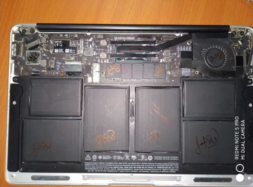 MacBook Pro battery cells and logic board replacement in progress at Solutionhubtech — MacBook battery repair in Kashmiri Gate