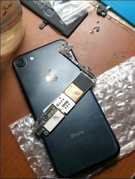 iPhone logic board and motherboard exposed during component-level diagnosis — iPhone motherboard repair in Vaishali at Solutionhubtech